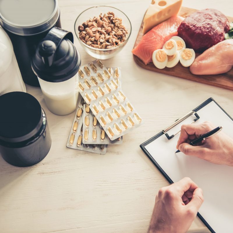 Cropped,Image,Of,Handsome,Young,Sportsman,Making,Notes,While,Preparing